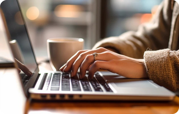 Invincible E-Transfer, woman is typing very fast, her transactions through Invincible Pay move at very fast speeds like her typing.