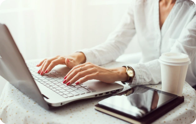 Invincible Pay Direct Deposit, Hands typing on keyboard, overhead view.