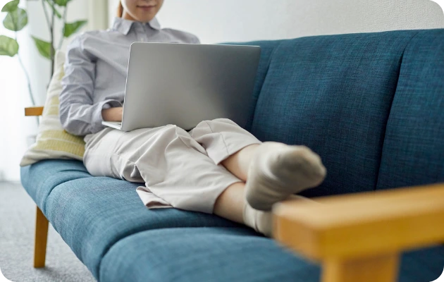 Invincible Pay Bill Payment, Person relaxed on couch with phone, bills paid automatically