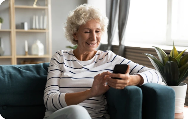 Invincible Pay Bill Payment, Person looking at phone with payment confirmation