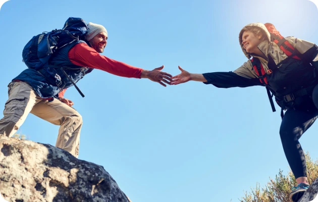 Invincible Pay Wire Transfer, Pair of happy campers, reaching out for each others hand on a mountain